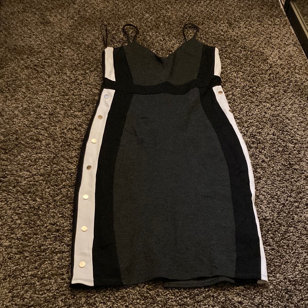 It is a short dress. It is grey,white, black. It has a zipper in the back.